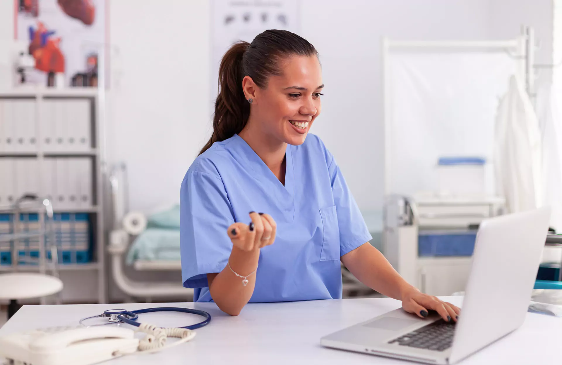 Nurse smiling at Laptop