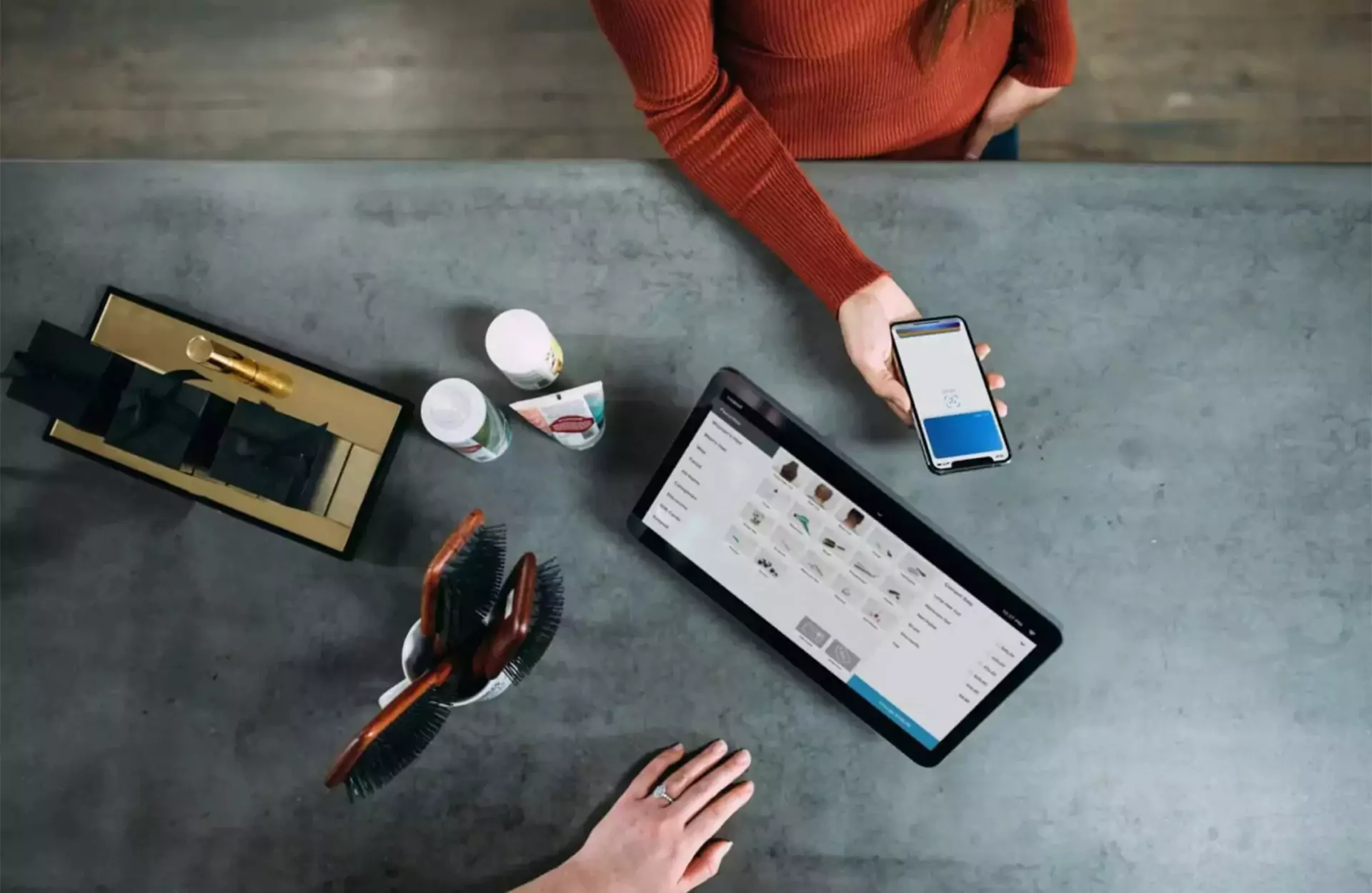 Woman at POS checkout with Phone ready to pay